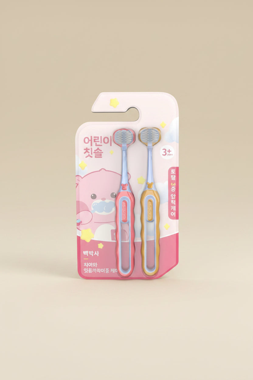 Two children's toothbrushes in a pink packaging with cartoon character on a white background