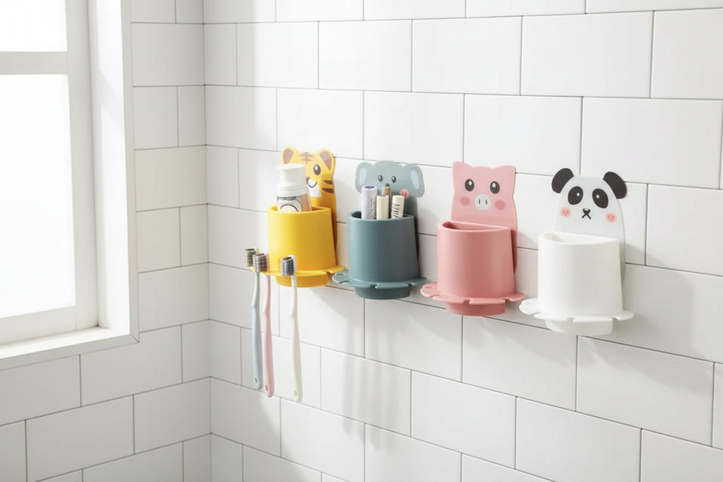 Four colorful animal-themed toothbrush holders on a light green wall.