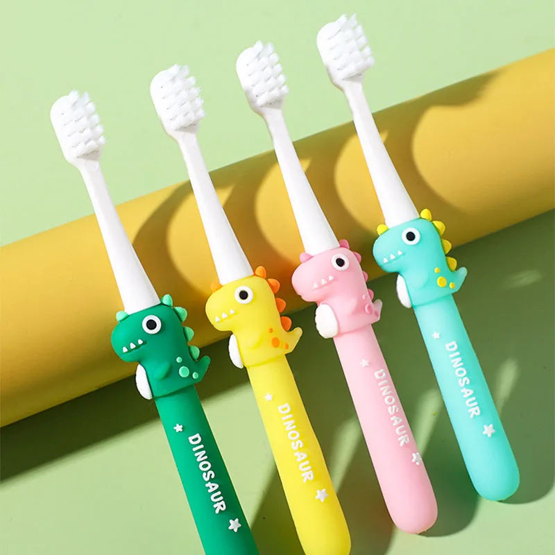 Five dinosaur-themed children's toothbrushes on a green background