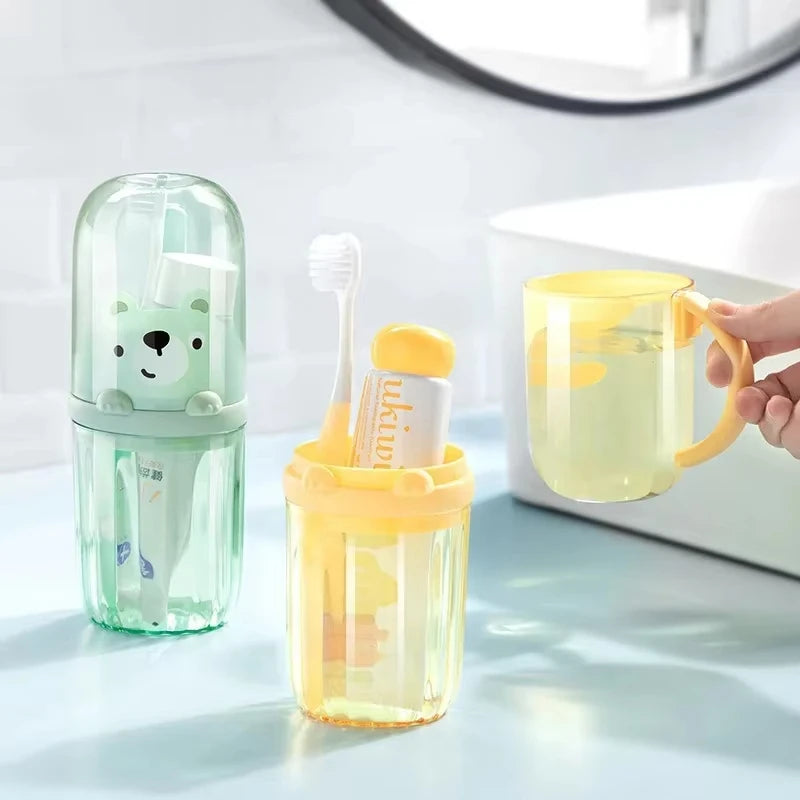 Set of dental care products including a green case with a cartoon character, a yellow cup, and a toothbrush on a light surface.